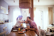 © Geber86 - Cute little girl playfully feeding father during breakfast in the kitchen
