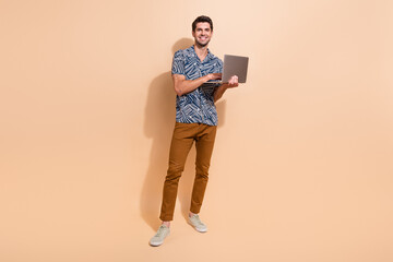 Aufkleber - Full length photo of young model guy wearing casual clothes when works remotely as system administrator isolated on beige color background