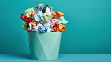 The Iron Trash Can Is Filled To The Top With Colored Crumpled Used Paper. The Concept Of Searching For A New Idea, Business. Place For Text