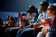 © Drazen - Happy black man and his family watching 3D movie in cinema.