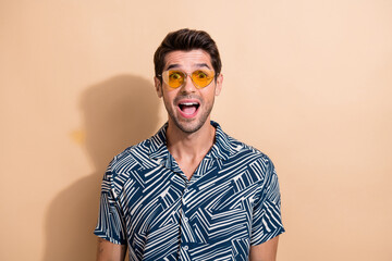 Poster - Photo of astonished impressed man open mouth dressed trendy clothes wow offer cool sale isolated on beige color background