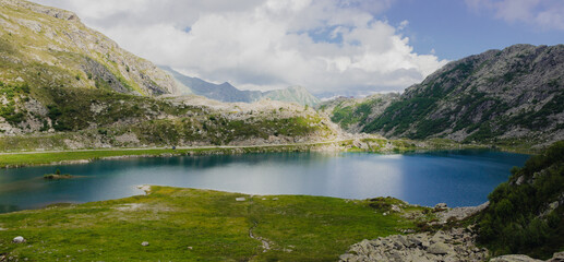 Wall Mural - Beautiful mountain landscape. Magnificent scenery with
the intense blue lake of Cornisello which occupies the bottom of a valley. Southern Rhaetian Alps in Val Nambrone in Trentino, Italy.