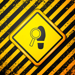 Wall Mural - Black Magnifying glass with footsteps icon isolated on yellow background. Detective is investigating. To follow in the footsteps. Warning sign. Vector