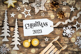 Fototapeta  - Rustic Wooden Christmas Background, Bokeh, Label With Text Christmas 2023