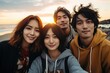© suphakphen - Selfie of young smiling multinational, Multi Ethnic teenagers having fun together. Best friends taking selfie outdoors on the beach. Happy young people having fun and travel together.