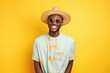 Smiling young black male hipster looking at the camera on a studio shot on yellow background
