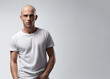 Young handsome bald man with white mock up t-shirt. Copy space