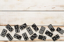 Black Domino Tiles On Wooden Background, Top View