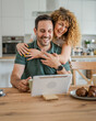 happy couple man and woman husband and wife morning routine use tablet