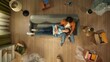 © kinomaster - Top view of apartment living room. Man sitting on the sofa woman laying on his legs, happy expression, talking together.