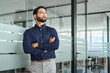 © insta_photos - Serious Indian business man looking away standing arms crossed in office. Confident bearded businessman ceo leader, professional manager executive or entrepreneur thinking of new project ideas.