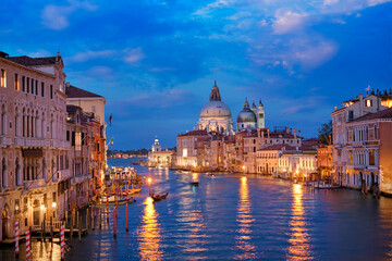 Wall Mural - View of Venice Grand Canal with boats and Santa Maria della Salute church in the evening from Ponte dell'Accademia bridge. Venice, Italy