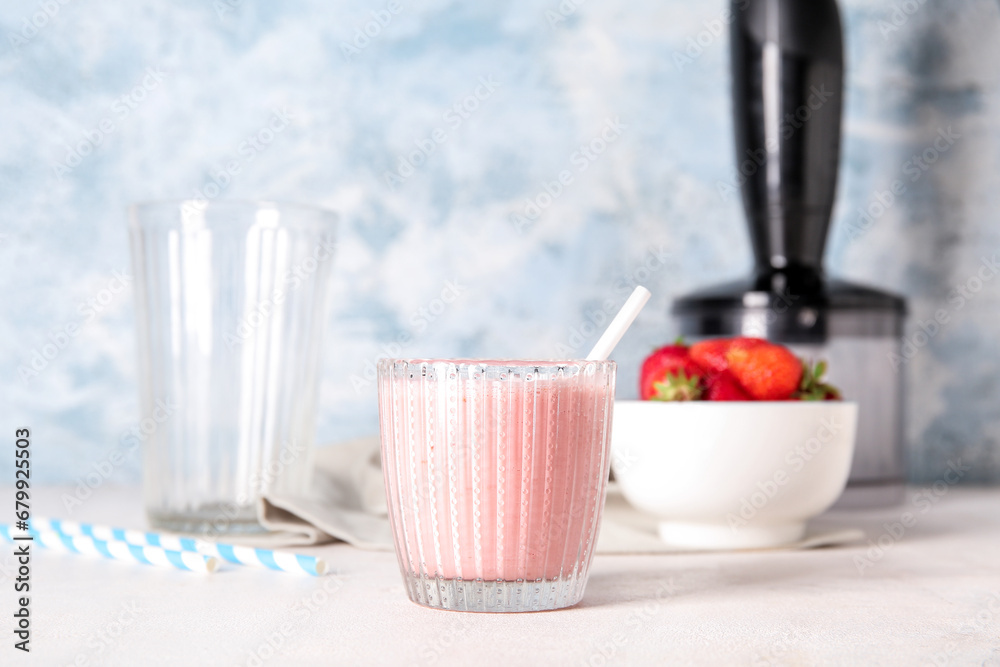 Glass of tasty strawberry smoothie on table