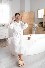 Poster - Young woman with facial mask in bathroom