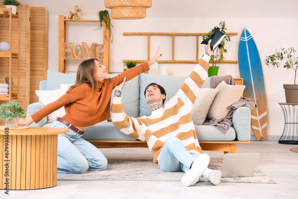 Young couple with VR glasses at home