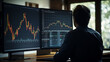 © AspctStyle - Back view of businessman or trader working with graph and stock market graph on computer at his desk