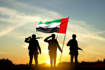Silhouettes of soldiers with the flag of UAE against the sunset. Armed forces of United Arab Emirates. Concept for Commemoration Day, Martyrs Day, National Day