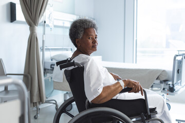 Wall Mural - African american senior female patient in wheelchair in sunny hospital room