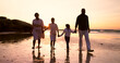 © Charlize D/peopleimages.com - Family, walking and holding hands on beach at sunset in summer, holiday or vacation with love. Parents, children or support with care and travel with insurance or security together at sea or ocean