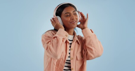 Poster - Happy woman, headphones and dancing to music, audio or sound track against a studio blue background. Female person smile and enjoying podcast or streaming in happiness with headset on mockup space