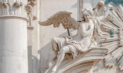 Wall Mural - Venice, Italy. Beautiful angel with wings and light. Church Chiesa di Santa Maria Assunta, Baroque catholic church with sacred medieval art