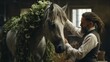 A groom meticulously braids a horse's mane for an upcoming show.