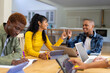 © Wavebreak Media - Happy diverse group of teenage friends studying with laptop and tablets at table at home