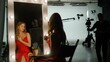 © kinomaster - The actress is preparing to film a movie. She sits in front of a mirror on the set and applies makeup to herself. Backstage concept