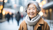 Elderly asian woman in winter in the city with copy space
