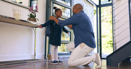 Back to school, getting ready and a girl student with her dad in their apartment together to say goodbye. Black family, kids and a man parent helping his daughter with her backpack while leaving home