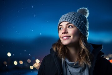Wall Mural - Portrait of a blissful woman in her 30s sporting a trendy beanie against a sparkling night sky. AI Generation