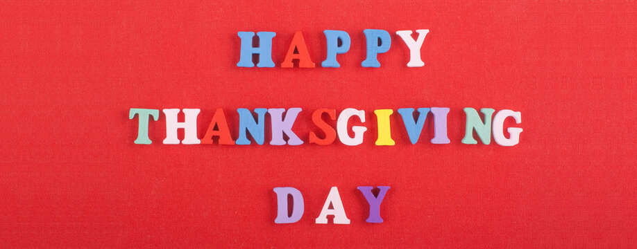 HAPPY THANKSGIVING DAY word on red background composed from colorful abc alphabet block wooden letters, copy space for ad text. Learning english concept. Banner.