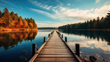 Fototapeta Pomosty - wooden bridge over the lake, Old wooden pier at sunset. Long exposure, linear perspective