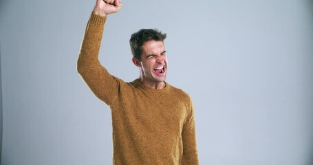 Wall Mural - Happy man, fist pump and celebration for good news, winning or cheering against a gray studio background. Portrait of isolated excited male person in achievement, bonus or promotion on mockup space