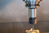 Fototapeta  - The CNC milling machine cutting the graphite electrode parts.