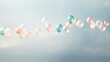  a group of balloons floating in the air on a cloudy day with a blue sky in the back ground and white clouds in the sky in the middle of the background.
