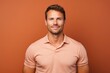 © CogniLens - Portrait of a satisfied man in his 30s wearing a sporty polo shirt against a pastel brown background. AI Generation