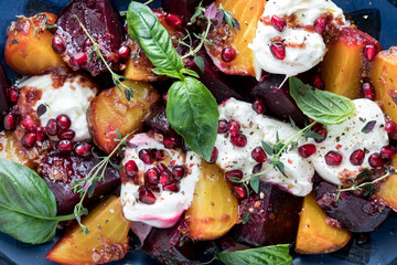 Roasted beets with burrata cheese, herbs and pomegranate seeds.