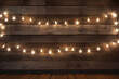 Lightup star studded lights on wooden wall. Festive Christmas background. Copy space for text.