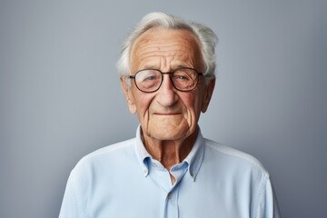 Poster - Portrait of a smiling elderly 100 years old man dressed in a casual t-shirt against a minimalist or empty room background. AI Generation