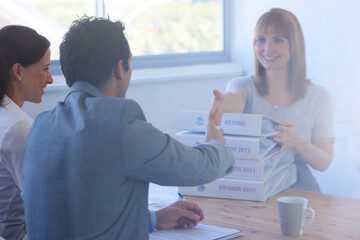 Poster - Woman, employer and handshake in interview for welcome, onboarding and hiring in office or workplace. Business, professional and people with documents, paperwork or shaking hands in meeting or smile