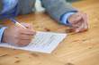 © Nicola Katie/peopleimages.com - Hands, writing and document with employment application, man and employee with insurance, signature and contract. Person, consultant or worker with pen, agent and checklist with compliance or policy