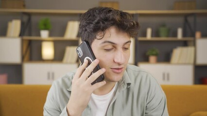 Young man chatting happily on the phone.