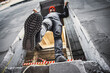 A construction worker steps into an unguarded, dangerous opening at a construction site. Violation of safety regulations at a construction site.