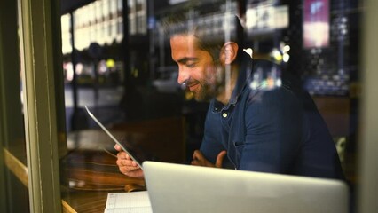 Wall Mural - Tablet, thinking and remote work with a man in a coffee shop for research as a freelance employee. Technology, idea and window with a young entrepreneur in a restaurant for his small business startup