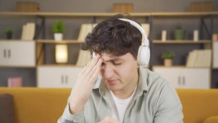 Unhappy young man using phone.