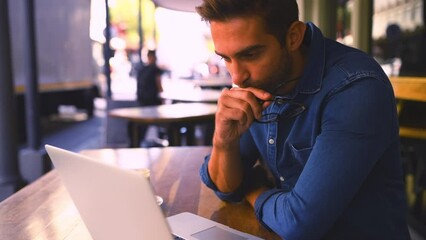 Poster - Laptop, thinking and remote work with a freelance man in a coffee shop for planning or research. Idea, smile and glasses with and a young employee working at a cafe as an entrepreneur in a startup