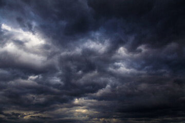 Wall Mural - Epic Storm sky with many dark grey black cumulus rainy clouds against blue sky background texture, thunderstorm