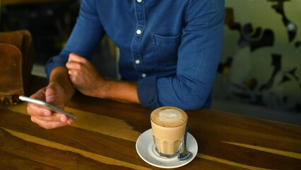 Poster - Hands, phone and coffee with a customer in a cafe closeup from above for social media or communication. Mobile, contact or networking and a person in a restaurant with a caffeine beverage to relax