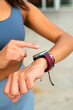 © ADDICTIVE STOCK - Young woman tracking fitness progress with a smartwatch